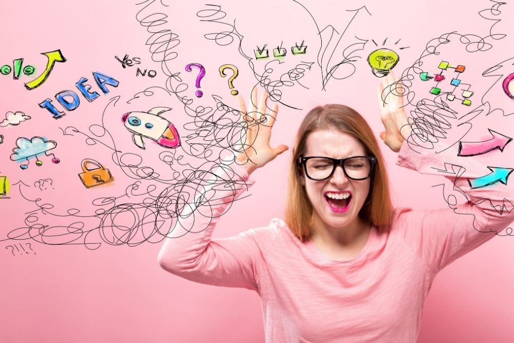 Image of a stressed looking lady against a pink background. There are icons & stress scribbles coming out of her head