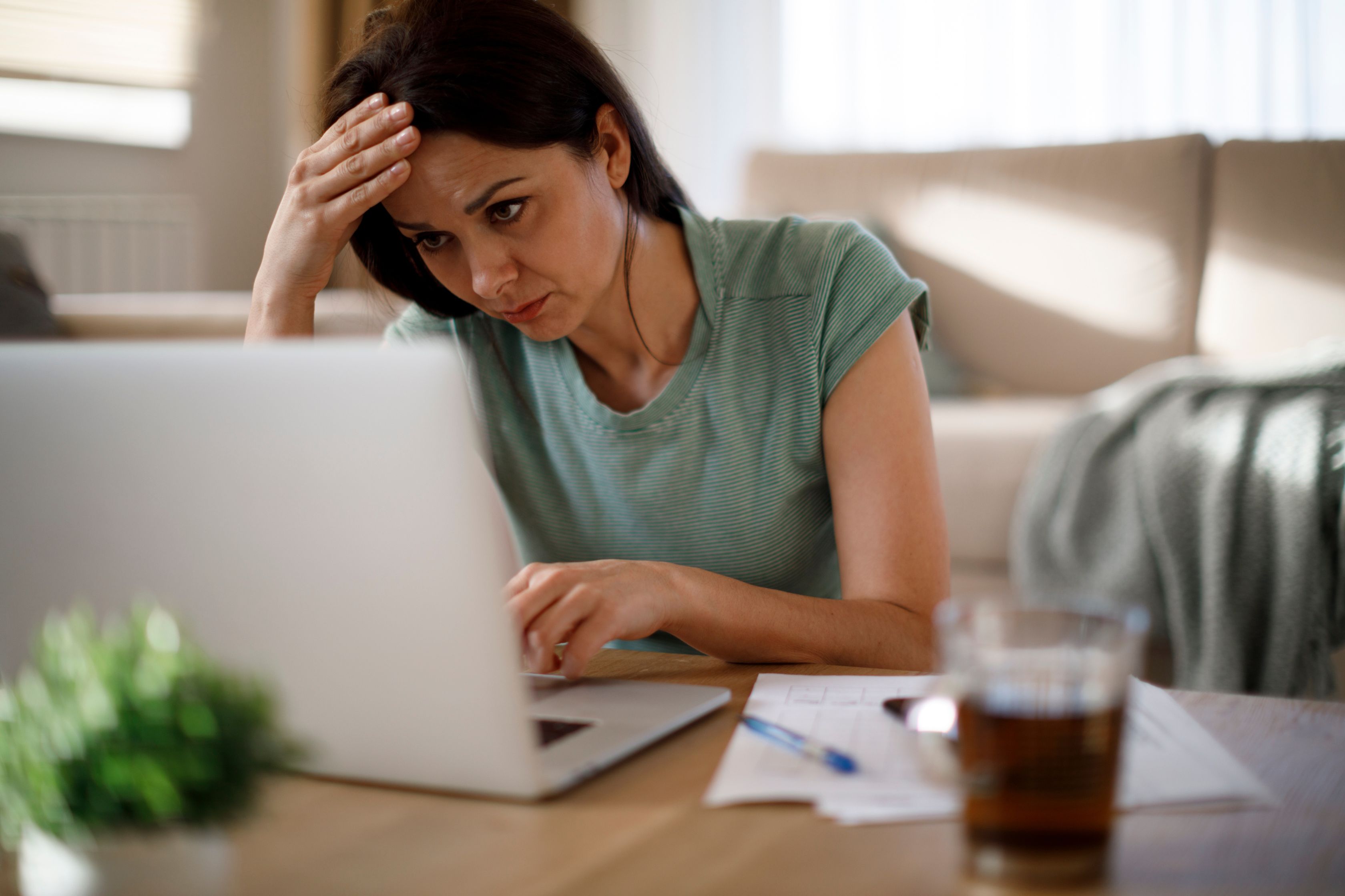 Confused woman looking at a laptop